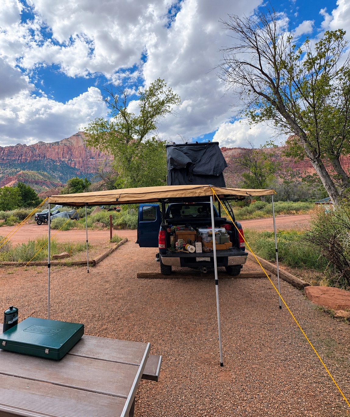 Truckie set up at a desert campsite with the side awning out