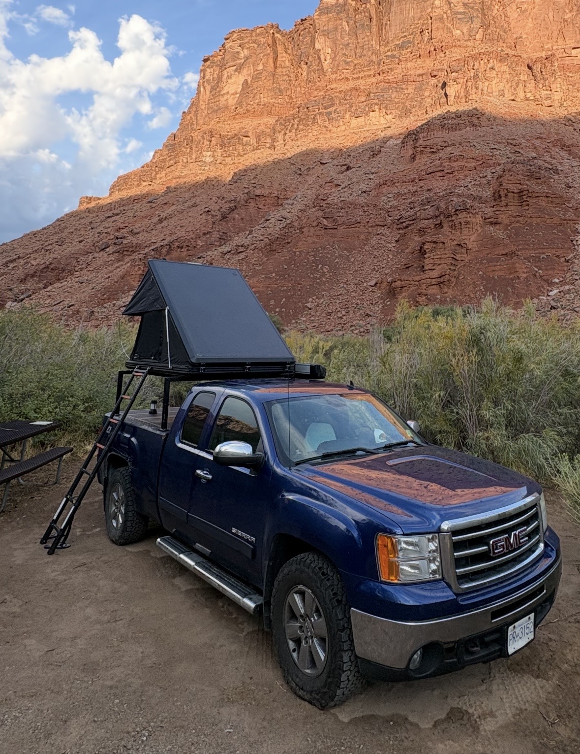 Truckie, a GMC Sierra 1500 with a roof top tent, parked below a canyon wall